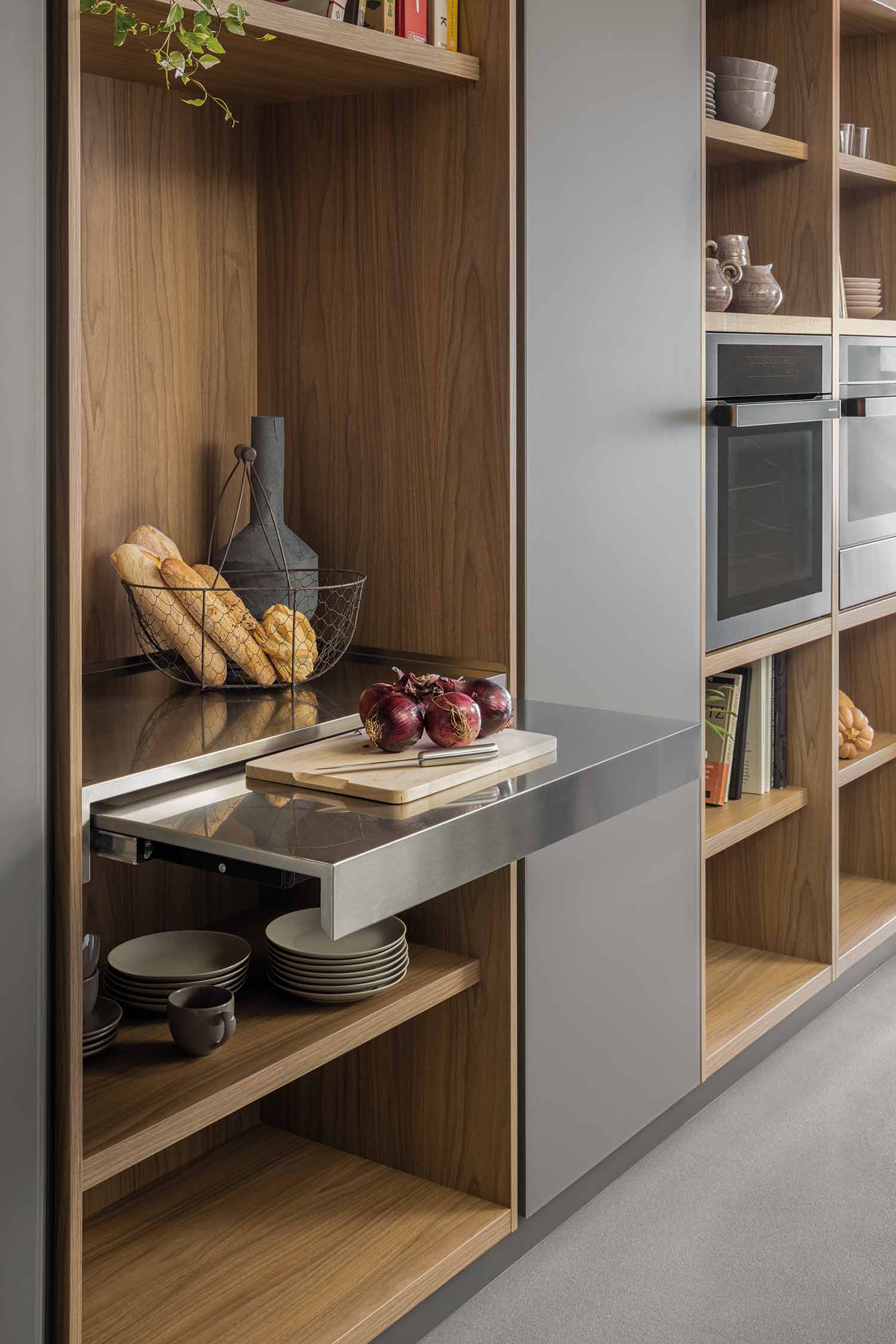 Pull-out stainless steel food preparation area from the kitchen tall unit